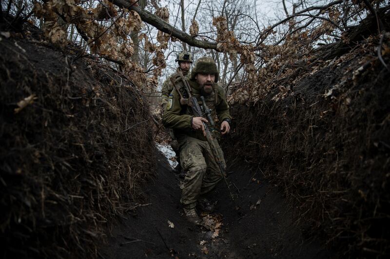 Ukrainian soldiers with the 79th Air Assault Brigade trudge through mud and water in the trenches around Marinka, in eastern Ukraine. Photograph: Tyler Hicks/New York Times