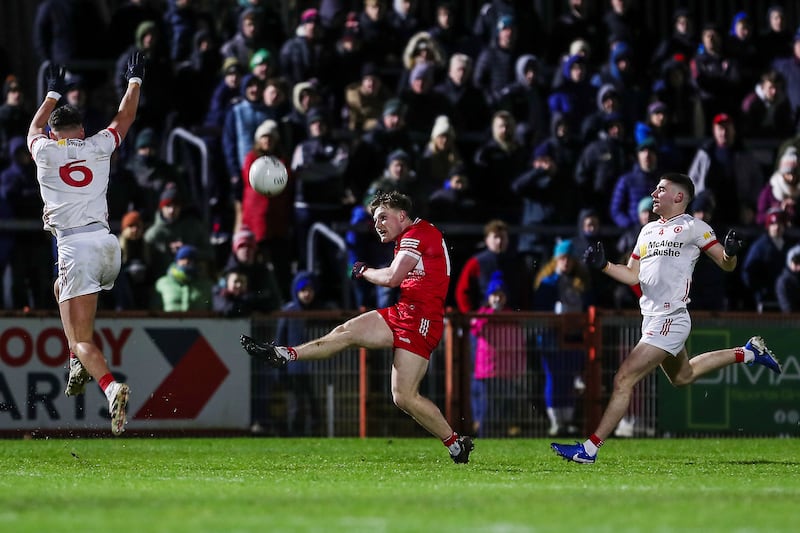 Derry’s Ethan Doherty takes a shot as he comes under pressure from Tyrone's Michael McKernan. Photograph: Lorcan Doherty/Inpho