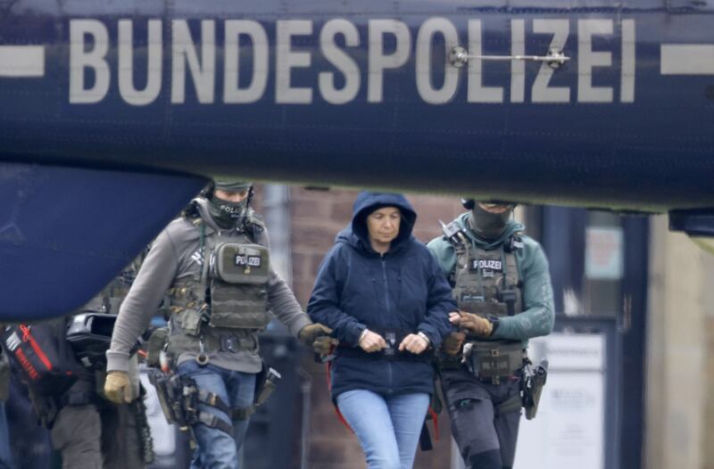 Federal police officers escort Daniela Klette, a former member of the Red Army Faction. She was recently arrested in Berlin after more than 30 years on the run. Photograph: Ronald Wittek/EPA