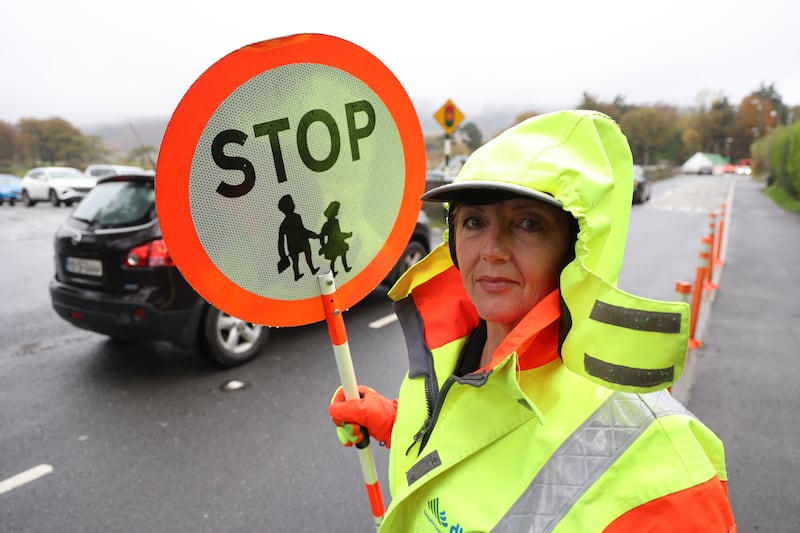 Lollipop lady Fiona Ryan at work outside Glencullen National School in the Dublin mountains. Glencullen is one of the highest villages in Ireland. Photograph: Nick Bradshaw