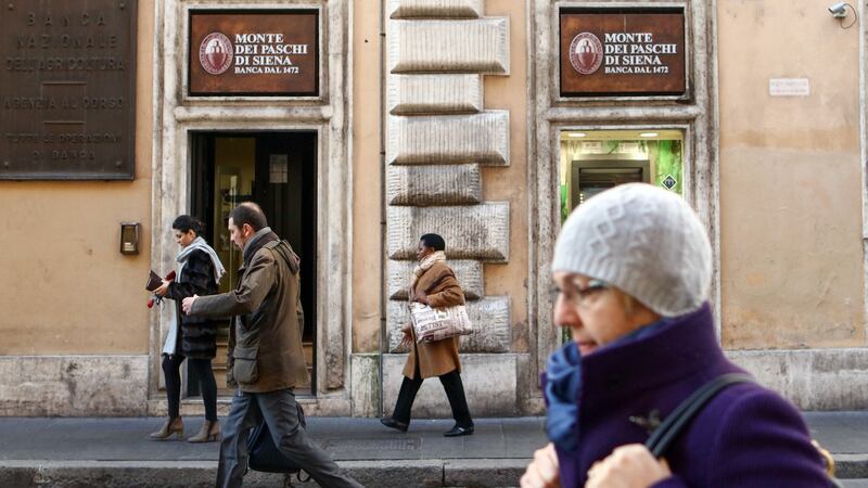 Pedestrians pass a branch of Banca Monte dei Paschi di Siena after the Italian vote on constitutional reform referendum in Rome. Photograph: Chris Ratcliffe/Bloomberg