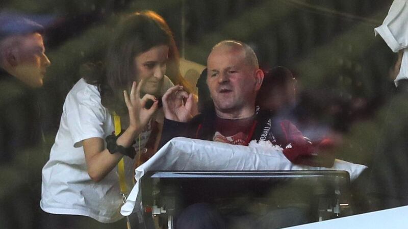 Sean Cox and his wife Martina signal to the crowd ahead of the game at the Aviva Stadium. Photograph: Ryan Byrne/Inpho