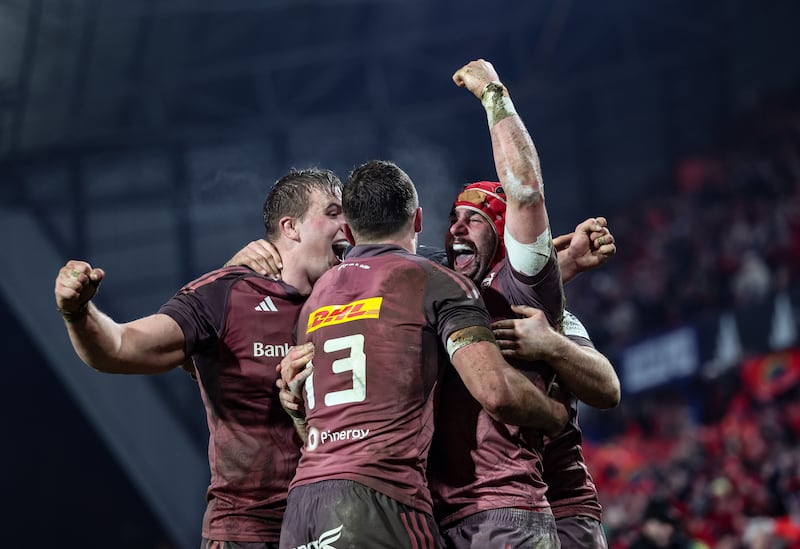 Munster’s John Hodnett celebrates with team-mates Gavin Coombes and Tom Farrell after scoring a try against Saracens. Photograph: Billy Stickland/Inpho