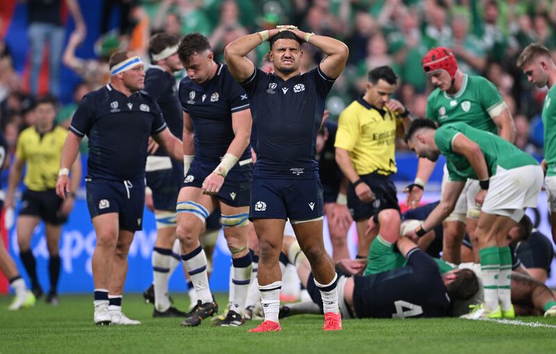 Scotland players are dejected after Ireland score a try at the Stade de France. Photograph: Stu Forster/Getty Images