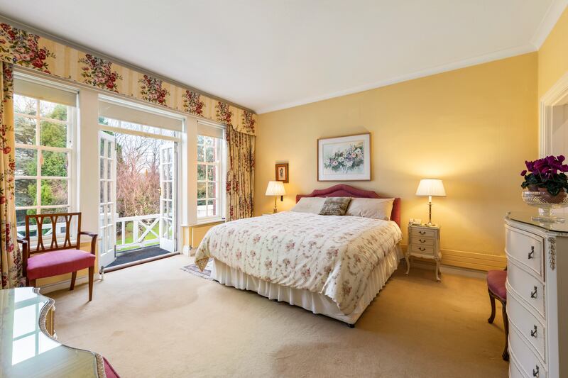 The main bedroom has a large walk-in wardrobe and, like the bedroom at the other end, doors to the wooden balcony.