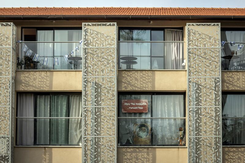 A sign in Hebrew reading 'My family is with Hamas in Gaza', a reference to hostages taken to Gaza after the October 7th attack by Hamas,  hangs in a window at a hotel in Shefayim, Israel, used for housing survivors. Photograph: Avishag Shar-Yashuv/New York Times
                      