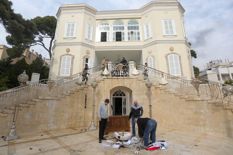 People remove the Syrian flag from the entrance of ousted president Bashar al-Assad's Al-Muhajirin residence in Damascus. Photograph: Bakr AL Kassem/AFP/Getty Images