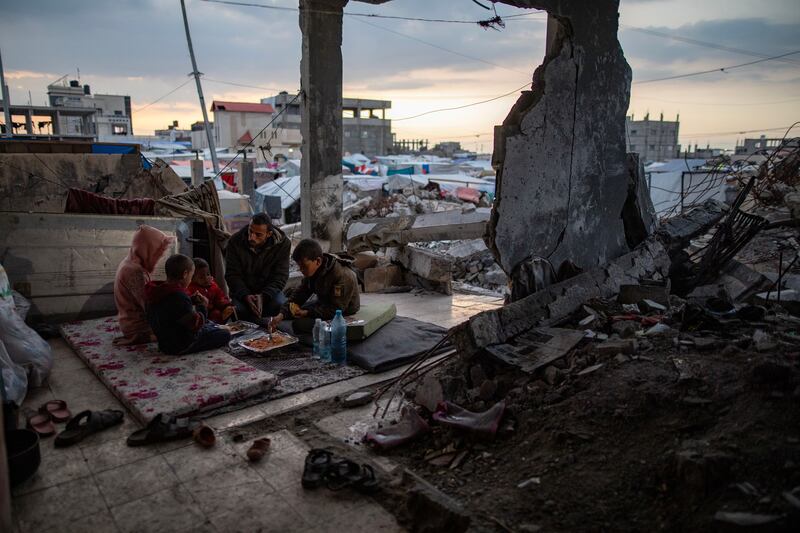 Muhammad al-Durra from Gaza City preparing for Iftar, the fast-breaking evening meal during Ramadan, with his family in a destroyed house in Rafah, southern Gaza Strip. Photograph: Haitham Imad/EPA