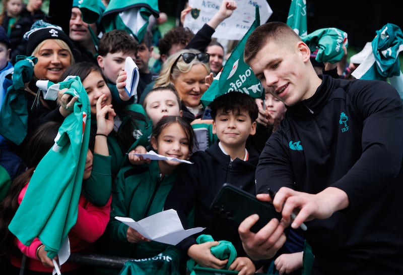 Sam Prendergast signs autographs for young Ireland fans. Photograph: Tom Maher/Inpho