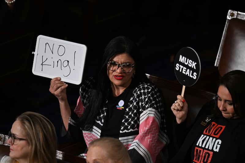 Democrat Rashida Tlaib (Michigan) holds up a “No king!” sign while protesting during Donald Trump’s speech. Photograph: Kenny Holston/The New York Times
                      