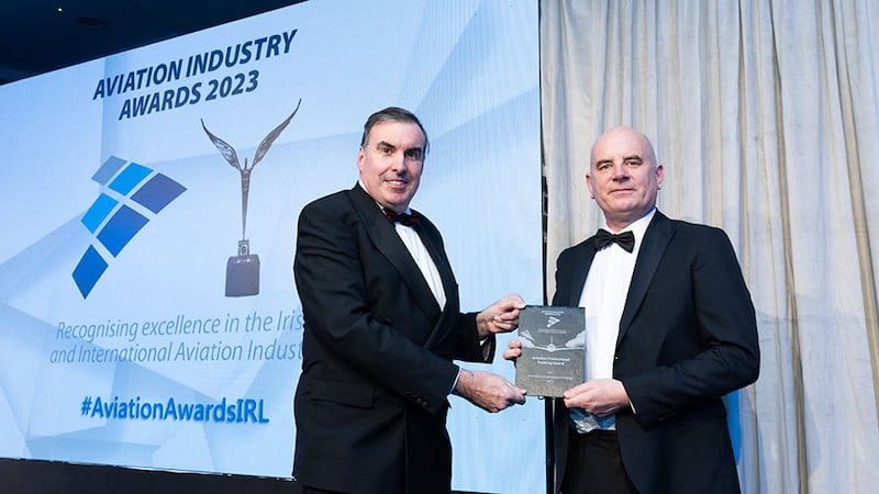 Patrick Edmond, awards judge, presents the aviation professional training award to Emmett Moran, International Aerospace Coatings