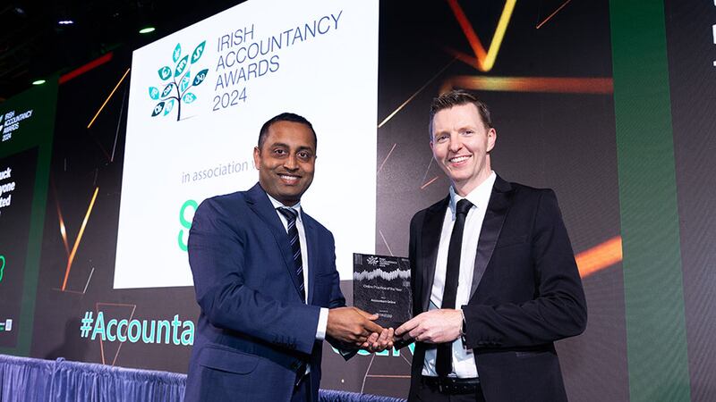 Pratheesh Chambeth, ceo, Capisso Ltd., presents the online practice of the year award to Tom Francis, Accountant Online.