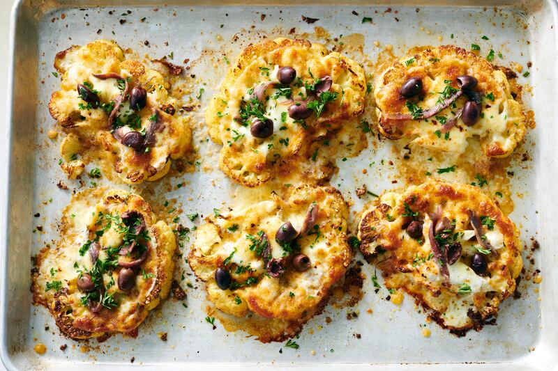 Lose the anchovies on these cauliflower steaks for a cheesy, delicious vegetarian main course. Photograph: David Malosh/The New York Times
                      