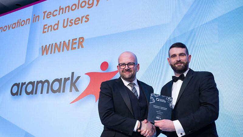 Stephen Byrne, regional manager ROI at H&J Martin presents the Innovation in Technology and Systems - End Users Award to Jason Keegan, Aramark.