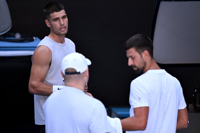 Spain's Carlos Alcaraz chats with Novak Djokovic of Serbia during a training session. Photograph: William West/AFP via Getty