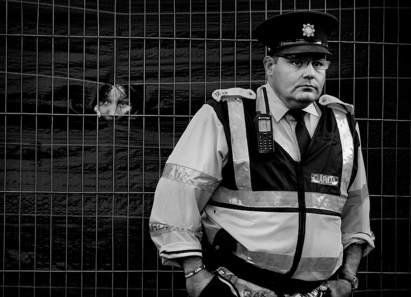 Aaron Lavery (13) from Thomas Street, Dublin, gets a sneak peek past Garda Michael McGrath atthe Dublin footballersÕ homecoming in Smithfield