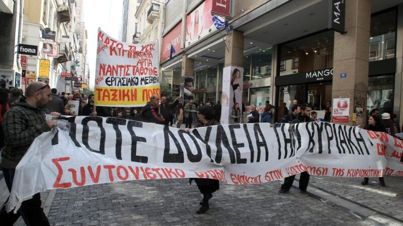 Shop employees hold banners reading ‘Never work on Sunday’ in Athens’ Ermou main shopping district, during a protest in opposition to Sunday shop opening. Many consumers took to the streets in the Athens shopping districts as department stores stayed open on Sunday due to the extra Easter shopping. Photograph: Simela Pantzartzi/EPA