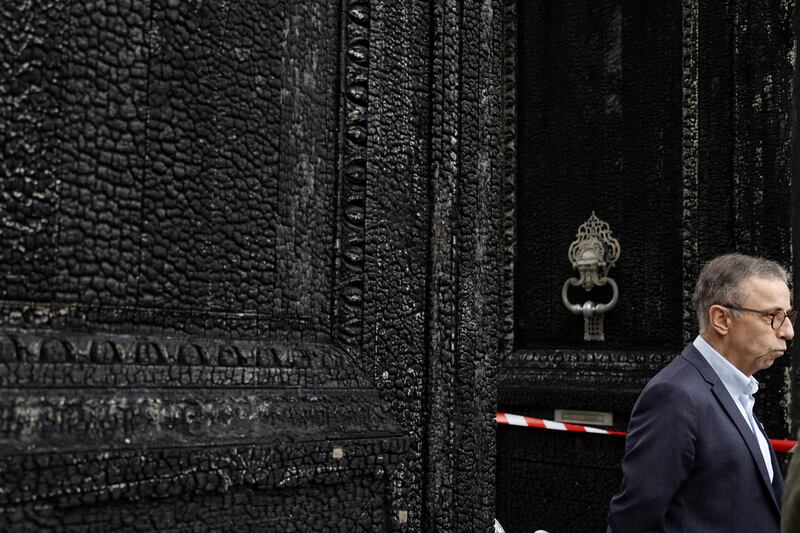 Pierre Hurmic, mayor of Bordeaux,  stands in front of the burned door of the city hall a day after it was set on fire by demonstrators during a rally against pension reform. Photograph: Romain Perrocheau/AFP via Getty Images