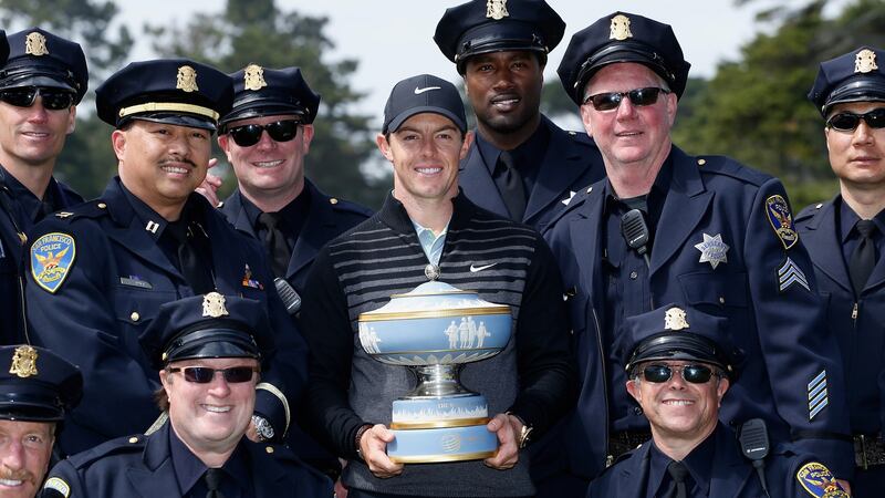 Rory McIlroy  poses with members of the San Francisco police department and the Walter Hagen Cup after defeating Gary Woodland 4&2 at the 2015  World Golf Championships Cadillac Match Play at TPC Harding Park. Photograph: Christian Petersen/Getty Images