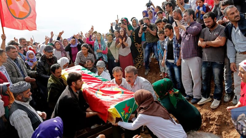 Mourners carry the coffin of one of four slain female Kurdish fighters, killed in clashes against Islamic State in Kobani, Syria, during a funeral at Suruc district, Sanliurfa, today. Photograpg: Tolga Bozoglu/EPA