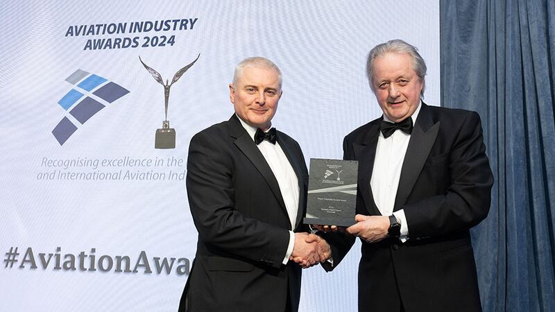 David Usher, awards judge, presents the airport hospitality provider award to Gerry Cregan, Marqette Dublin Airport