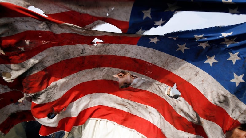 A US flag is defaced during an anti-US demonstration  in Tehran, Iran. Photograph: Abedin Taherkenareh/EPA