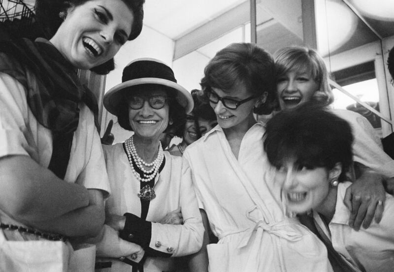 Coco Chanel with a group of models in the Chanel studio. Photograph: Douglas Kirkland/ Getty Images