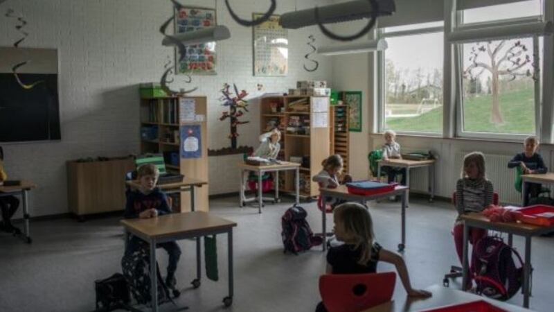 Primary school children sit at desks spaced about two yards apart, in Logumkloster, Denmark. Photograph: Emile Ducke/The New York Times