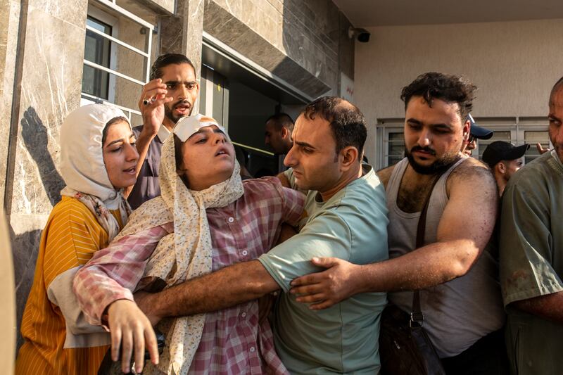 An injured woman outside Al Shifa Hospital in Gaza City. Photograph: Samar Abu Elouf/The New York Times