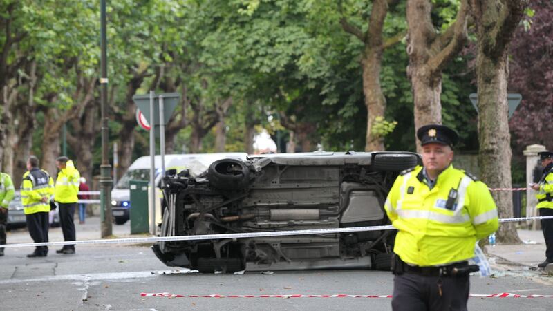 Gardaí preserve the scene at Adelaide Road, Dublin, where an upturned car that was in collision with pedestrians is visible.  Stephen Collins/Collins Photos