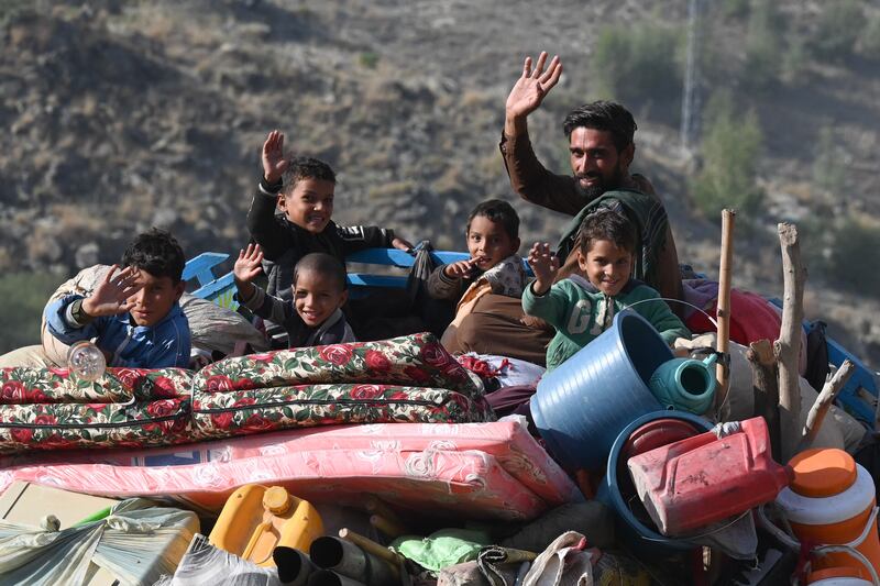 An Afghan refugee family waves from atop a truck heading towards the Pakistan-Afghanistan Torkham border crossing on Friday. Photograph: Abdul Majeed/AFP via Getty Images