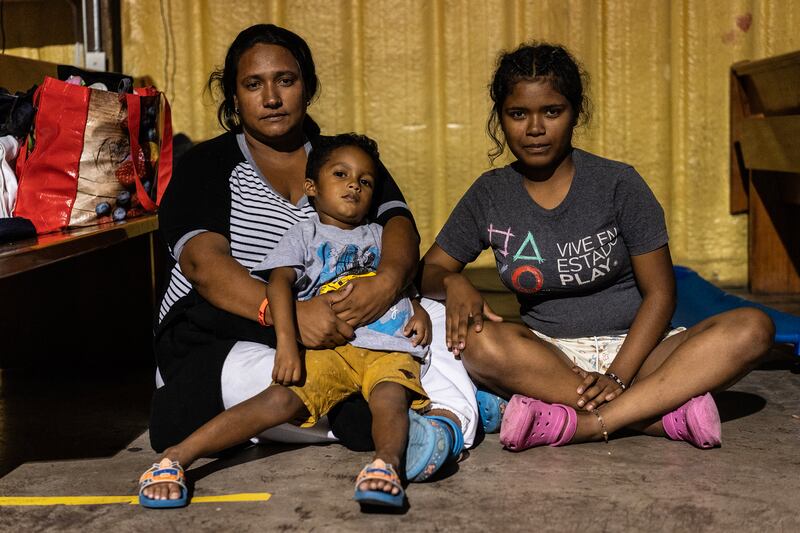 Marjorie Escobar with her family in a respite centre. Photograph: Go Nakamura/New York Times
                      