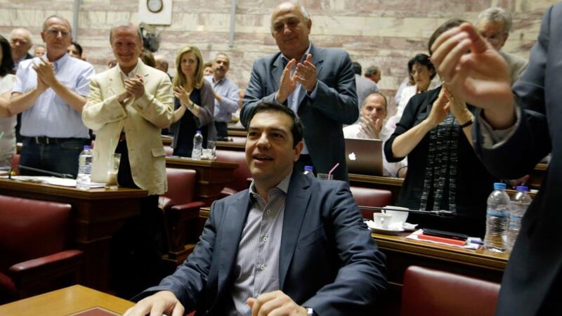 Greek prime minister Alexis Tsipras arrives for a meeting as members of his Syriza party applaud him at the Greek Parliament in Athens on Friday. Photograph: AP