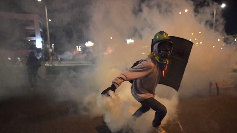 Demonstrators clash with riot police in Bogota. Photograph: Raul Arboleda/AFP via Getty Images