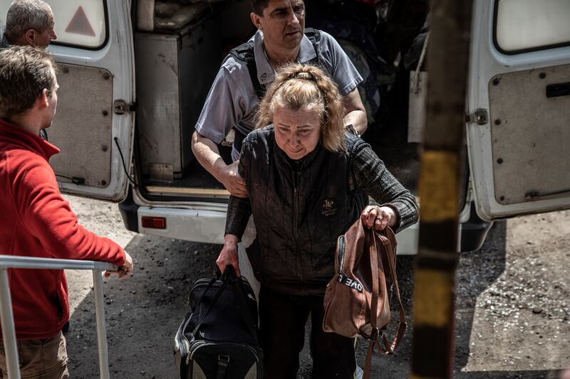 Olha, a resident of Sievierodonetsk, Ukraine, is assisted as she climbs down from the ambulance that was carrying her husband on Tuesday, May 24th. Her husband, Serhii, had died, another victim of the relentless barrage of artillery and gunfire Russian forces have rained down on the city. Photograph: Finbarr O'Reilly/New York Times