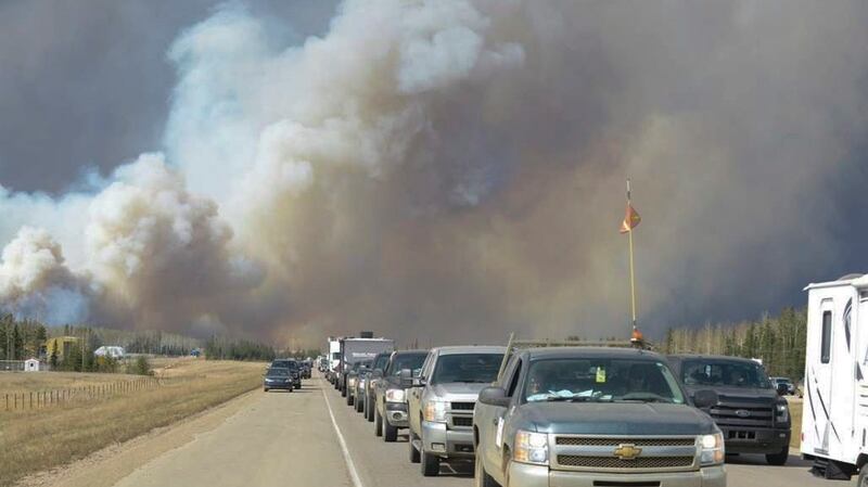 Smoke fills the air as people drive on a road in Fort McMurray, Alberta, Tuesday, May 3rd, 2016. Photograph: Greg Halinda/The Canadian Press via AP