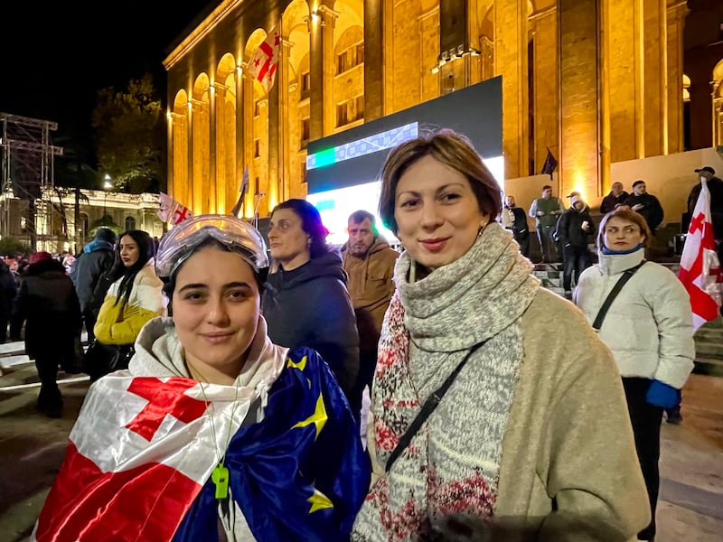 Elene Abdushelishvili and Nino Goginashvili, members of liberal Georgian opposition party Akhali, protest outside parliament in Tbilisi on Monday night. Photograph:  Daniel McLaughlin