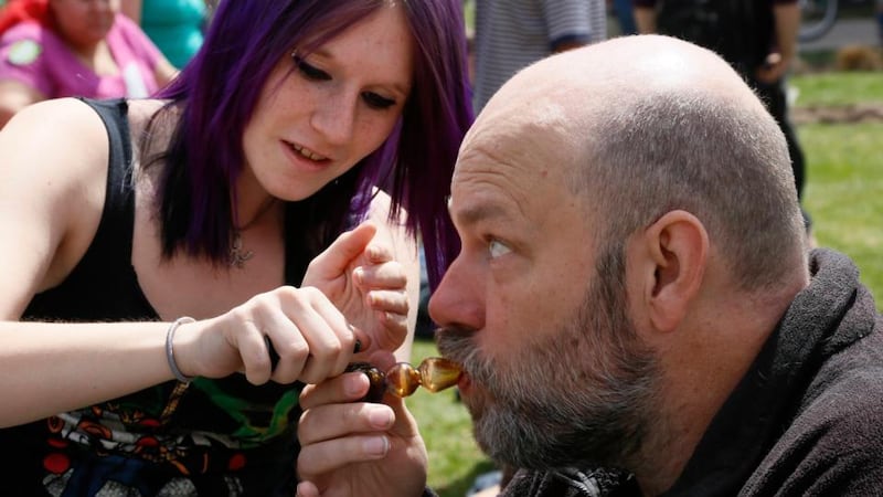 A participant at the 4/20 celebration smokes a pipe in Civic Center Park in  Denver yesterday. Photograph: Rick Wilking/Reuters