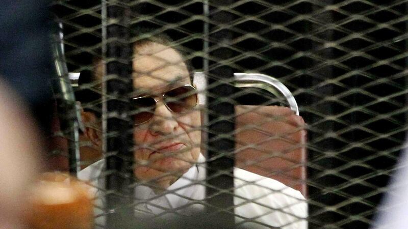 Former Egyptian president Hosni Mubarak behind bars during his retrial in 2013. File photograph: Getty Images