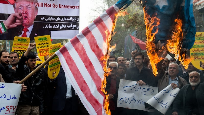 Protesters hold a burning American flag during a demonstration on the anniversary of the US embassy seizure in Tehran. Photograph: Ali Mohammadi/Bloomberg