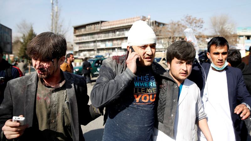 People assist an injured man after a blast in Kabul, Afghanistan, on Saturday. Photograph: Reuters