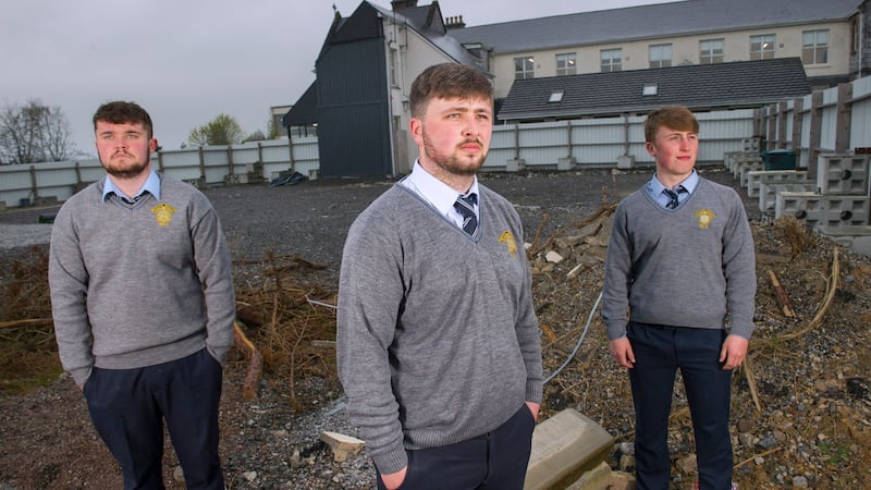 Eoghan Kenny (centre), with fellow students Sean O'Sullivan (left) and Luke Kennedy, at the site of the 2016 school fire at Patrician Academy secondary school in Mallow, Co Cork. Photograph: Daragh McSweeney/Provision