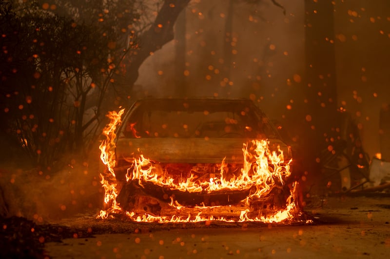 A car burns in the wildfire in Altadena, California on Wednesday. Photograph: Kyle Grillot/The New York Times
                      