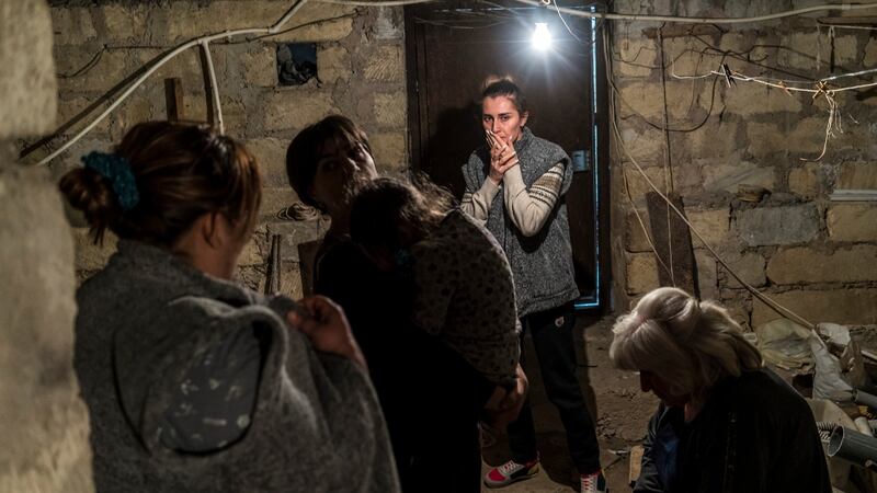 Residents shelter in a basement as air raid sirens sound on Tuesday in Stepanakert, Nagorno-Karabakh. Photograph: Brendan Hoffman/Getty Images