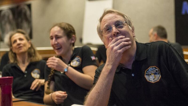 Members of the New Horizons science team react to seeing the spacecraft’s last and sharpest image of Pluto. Photograph: Nasa