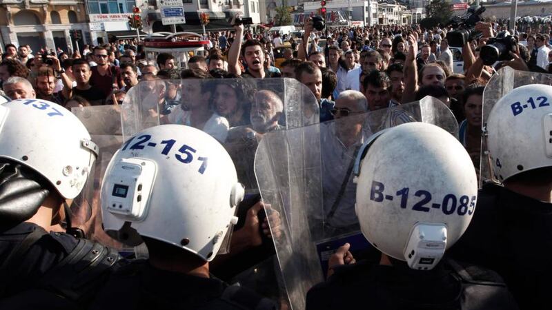 Riot police guard the entrance of Gezi Park as protesters shout slogans in central Istanbul earlier this year. Photograph: Osman Orsal/Reuters