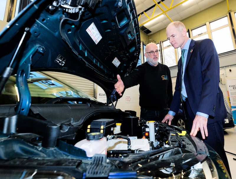 Andy Latham (left) of automotive recycling business Salvage Wire, tells Ossian Smyth, Minister of State with responsibility for Public Procurement, eGovernment and Circular Economy, about the Electric ELVES training programme for recycling electric vehicle batteries, at Plunket College, Dublin. Photograph: Maxwells