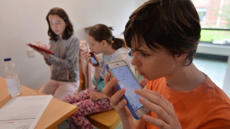 Emily Ginty, Eveline Lutere and Cormac O’Toole using assistive technology such as Seeing AI at a residential summer camp run by the NCBI for visually impaired children aged 13-18. Photograph: Alan Betson / The Irish Times