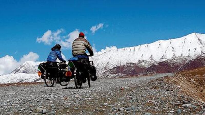 On the map: Diarmuid asks for directions during the Cunniffes' journey across Asia LONG AND WINDING ROAD Anna and Diarmuid Cunniffe on their bespoke bicycles