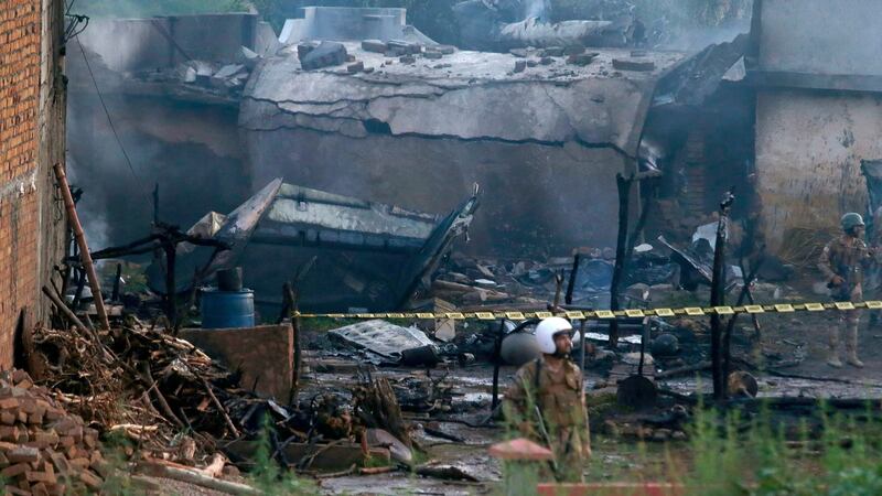 The site of a military plane crash in Rawalpindi, Pakistan, in which at least 17 people were killed. Photograph: Anjum Naveed/AP.